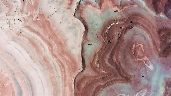 Top Down View on Traveler Woman Walking By Colorful Pattern of Red Desert Canyon