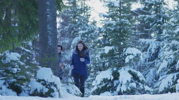 Girls running in the forest on a winter day