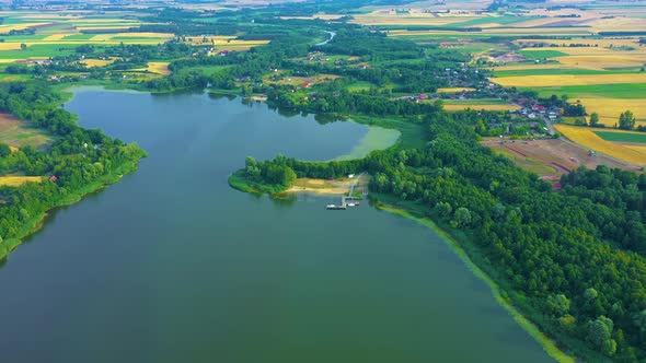 Epic Top Down Aerial View of Big Lake With Clear Blue Water. Reflection of Sky in Clear Lake in Even