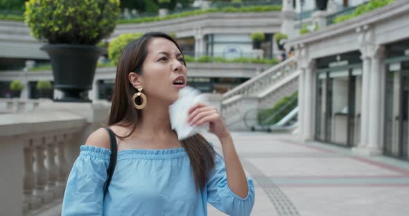 Woman feel so hot and use of tissue at outdoor