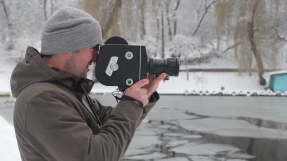 A Male Cameraman Shoots Video on an Old Vintage Camera Krasnogorsk in the Park in Winter. Kyiv