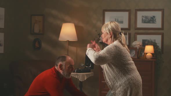 Elderly Couple Dancing Twist at Home