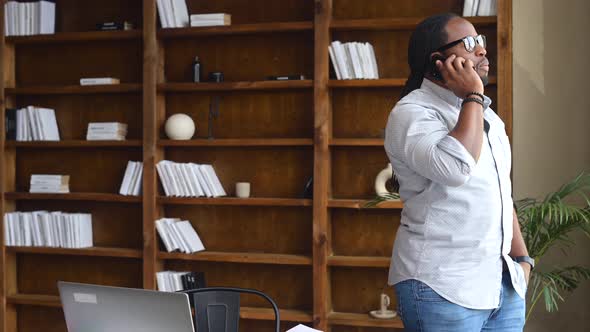 Young African American Male Employee Has Phone Call