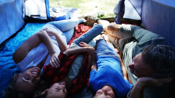 Family having fun in tent 4k