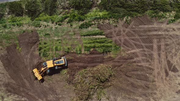 Bulldozer working on field. Top down view of excavator machine on field