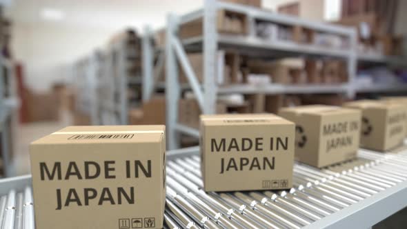 Boxes with MADE IN JAPAN Text on Warehouse Conveyor