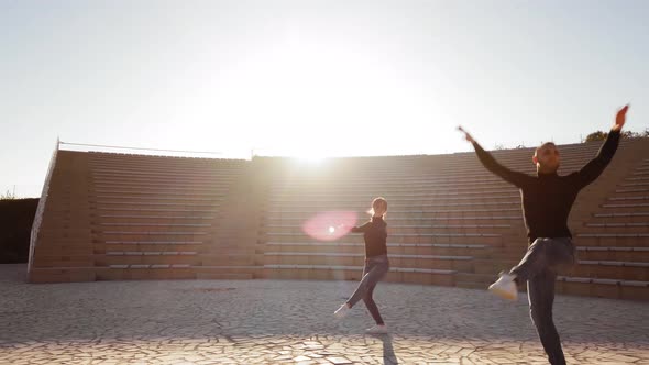 Dancers dance in an open-air theater