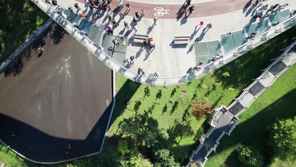 Aerial Top View of Pedestrian Glass Bridge with a Crowd of Walking People