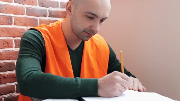 Construction engineer works with blueprints in the office.