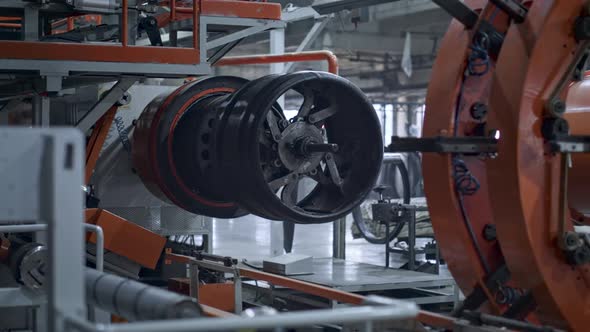 Automated Robotic Tire Manufacture Machine Moving at Automotive Workshop