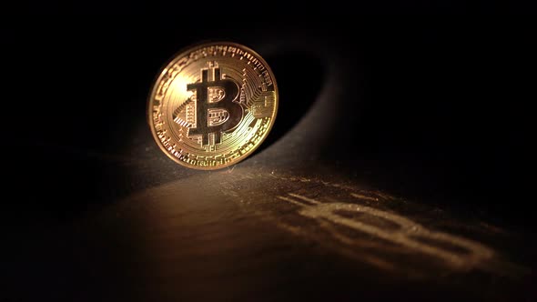 Shiny Bitcoin Rotating and Reflecting Light on a Wooden Surface
