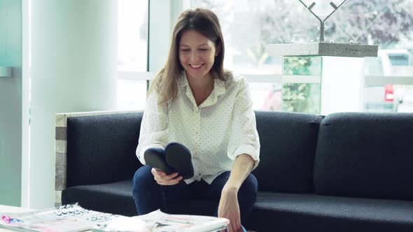 Woman admiring newly purchased shoes just delivered