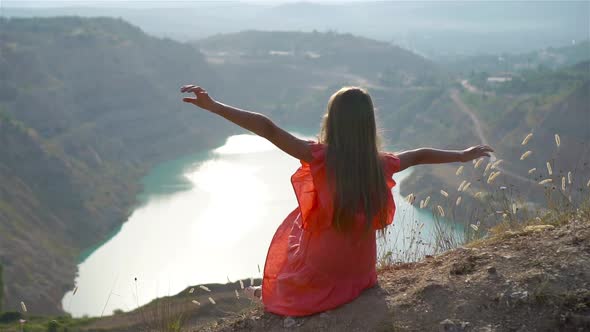 Little Girl Near the Lake at the Day Time with Amazing Nature on Background