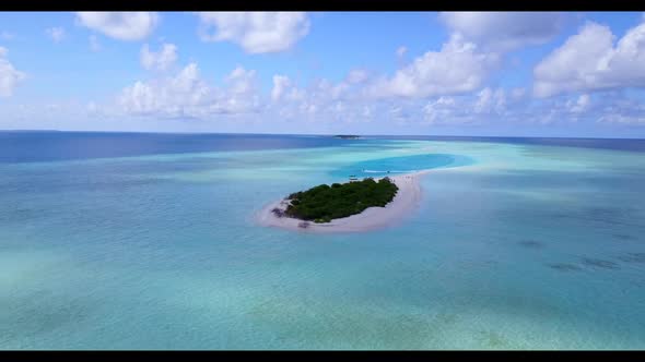 Aerial drone shot tourism of exotic seashore beach break by blue sea and white sandy background of a