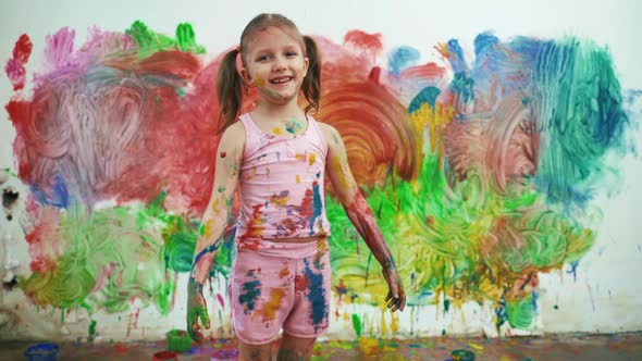 Little Girl Child Preschooler Draws Hands Paints On White Wall.