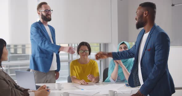 Diverse Business People Closing Deal and Shaking Hands After Negotiation Meeting in Office