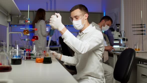 Young Scientist Mixing Colored Liquids