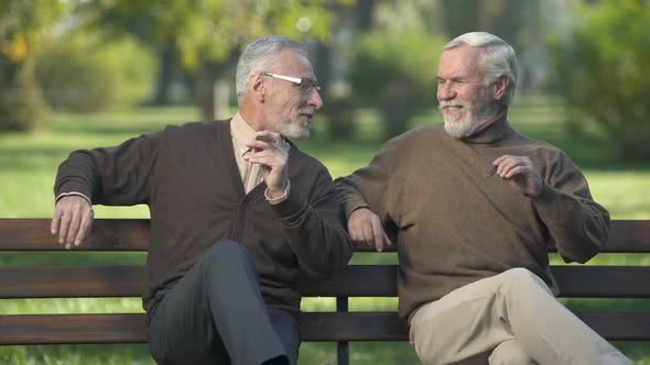 Male Pensioners Smoking Expensive Cigars