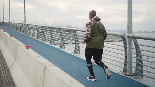 Athlete Man Run Training Air Workout on River Road in Awesome Landscape World