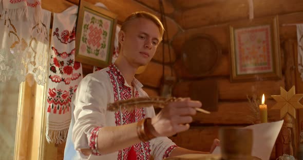 Closeup the Writing Pen is on the Table the Hand of the Slavic Man Takes the Pen and Begins to Write