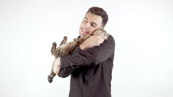 Young Handsome Man Holding and Hugging His Cat Isolated on White Background