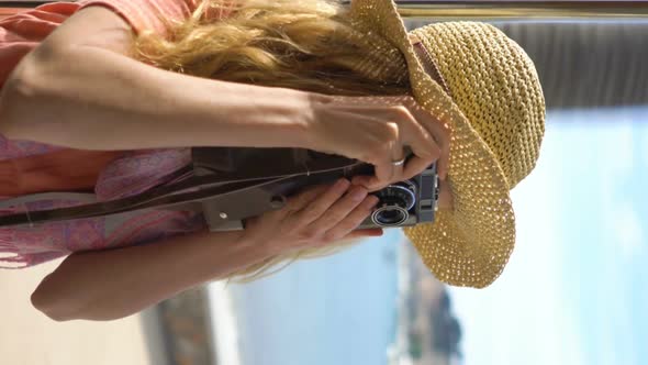 A Young Woman Wearing Straw Hat Enjoying Traveling on an Old Tram or Train Along Sea Coast. A