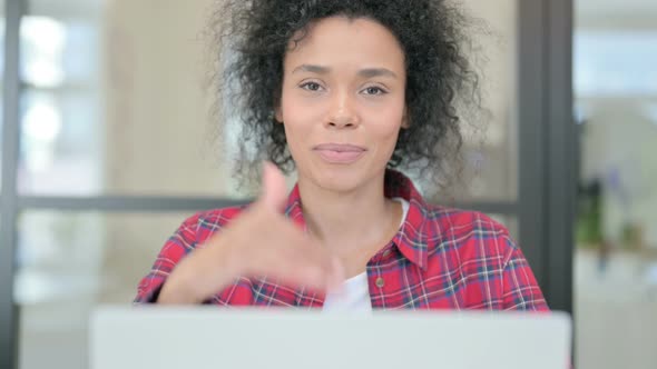 Close Up of African Woman with Laptop Showing Thumbs Up