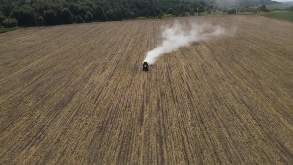 The Tractor Spreads Mineral Fertilizers To Improve The Harvest  