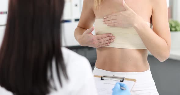 Woman with Elastic Bandage on Her Chest Showing Breast Doctor to Mammologist  Movie