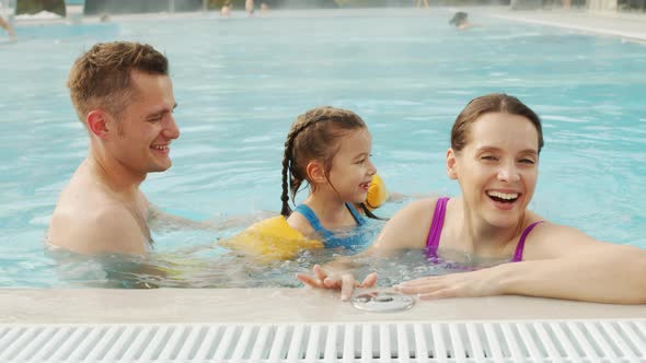 Joyful Family Having Fun In Pool