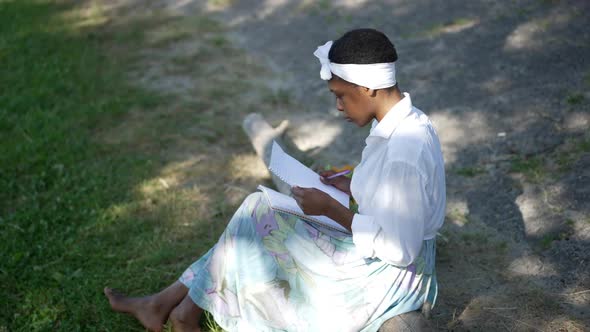 Side View Portrait of Romantic African American Young Woman Hugging Handwrite Letter Looking Away