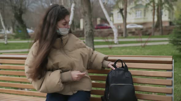 Side View of Young Woman Outdoors with Medical Face Mask for Protection of Virus. Concept