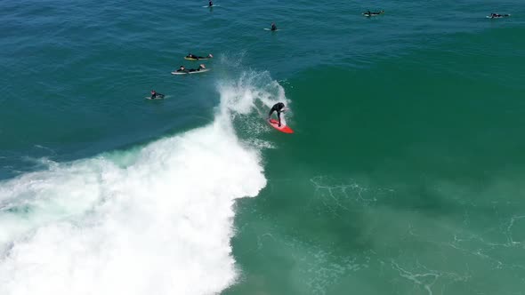 Aerial Shot Male Surfer Catches and Ride a Massive Barreling Waves