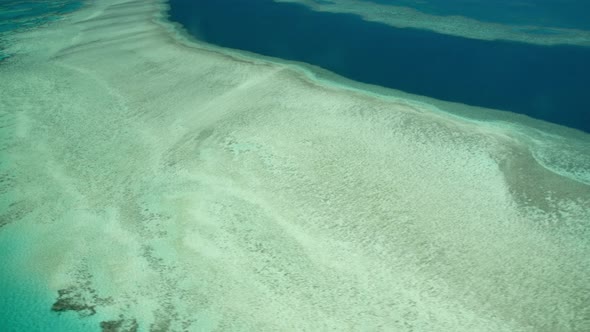 The Great Barrier Reef As Seen From the Airplane. Beautiful Ocean Colors, Aerial View. Slow Motion