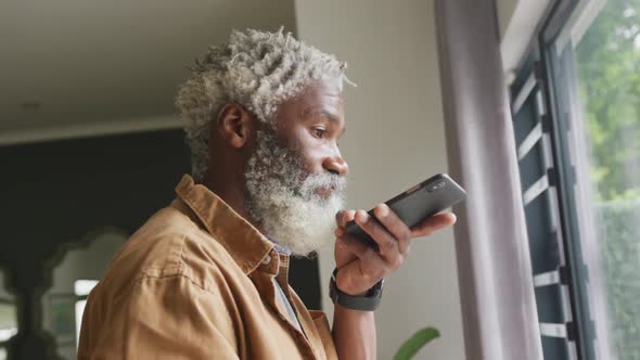 Video of african american senior man using smartphone