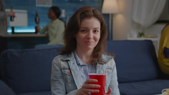 Portrait of Woman Sitting on Sofa Similing at Camera While Drinking Beer