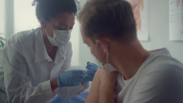 Guy Getting Covid Vaccination in Office Clinic Close Up