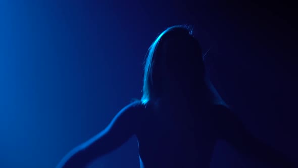 Young Passionate Woman Dances Disdain and Performs Flowing Movements with Her Hands. Close Up