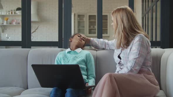 Mom Checking Temperature of Sick Daughter By Hand