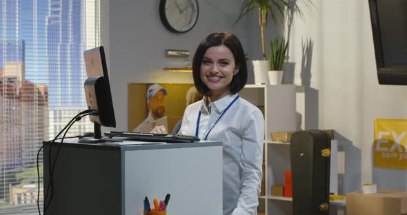 Customer Service Manager Standing By Desk