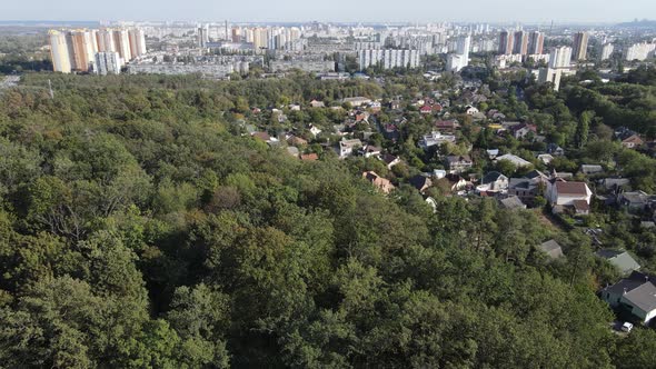 Megalopolis Next To the Forest: the Contact Between the Big City and Nature. Aerial View. Slow