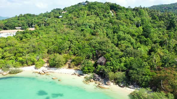 Tranquil secret exotic beach with white sand and turquoise lagoon with coral reefs on tropical islan