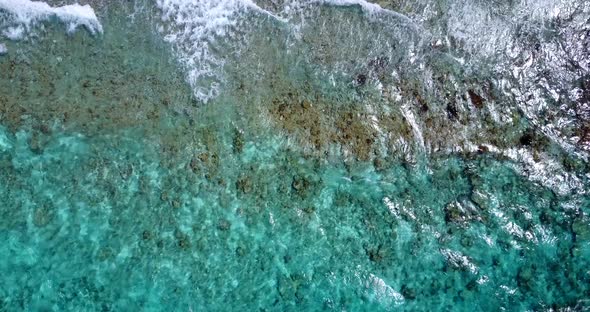 Wide above copy space shot of a sunshine white sandy paradise beach and blue water background in vib