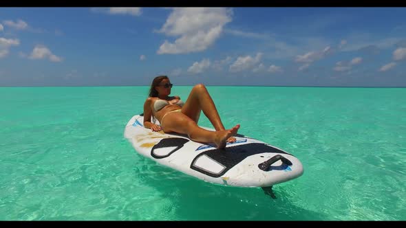 Ladies together happy together on perfect coast beach adventure by aqua blue sea and white sandy bac