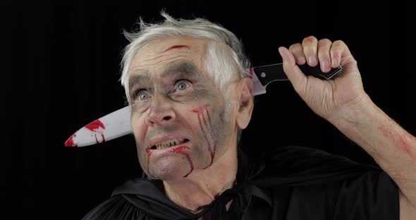 Elderly Man with Knife in Head. Halloween Makeup and Costume. Blood on His Face