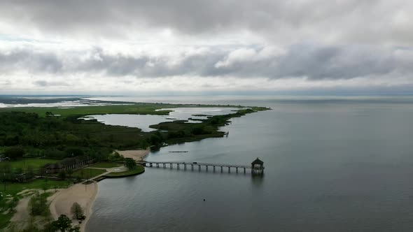 Fontainebleau Beach Pier In Lake Pontchartrain Basin, Mandeville, Louisiana On A Cloudy Day - aerial