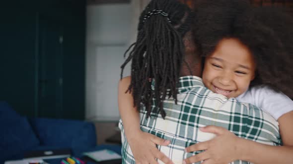 Close Up Portrait of Happy African American Girl Running to Her Father and Hugging Him Hard at Home