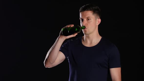 Alcohol Addiction, Man Drinking From a Bottle of Red Wine