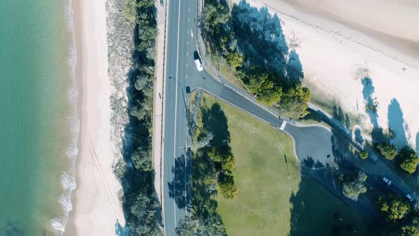 Aerial Flying Over Looking Directly Down On Road Outside Town, Daytime