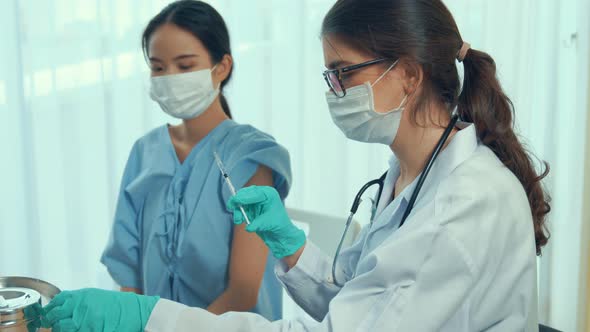 Young Woman Visits Skillful Doctor at Hospital for Vaccination